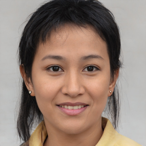 Joyful asian young-adult female with medium  brown hair and brown eyes