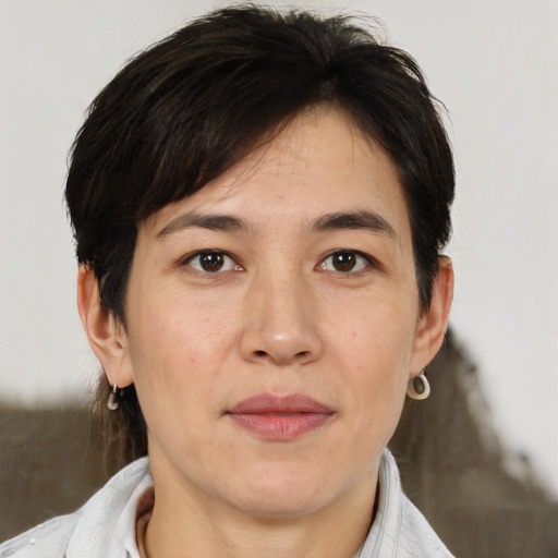 Joyful asian young-adult female with short  brown hair and brown eyes