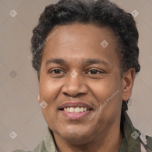 Joyful latino adult male with short  brown hair and brown eyes