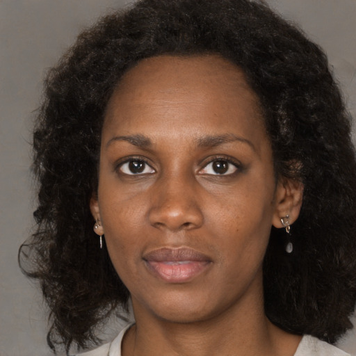 Neutral black young-adult female with medium  black hair and brown eyes