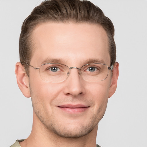 Joyful white adult male with short  brown hair and grey eyes