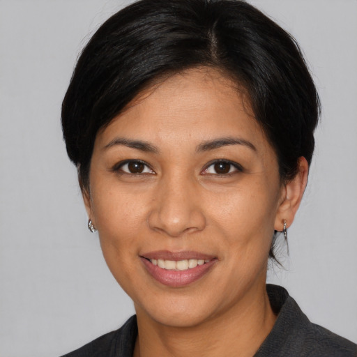 Joyful asian young-adult female with medium  brown hair and brown eyes