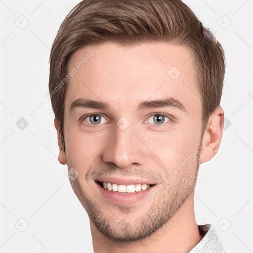 Joyful white young-adult male with short  brown hair and grey eyes