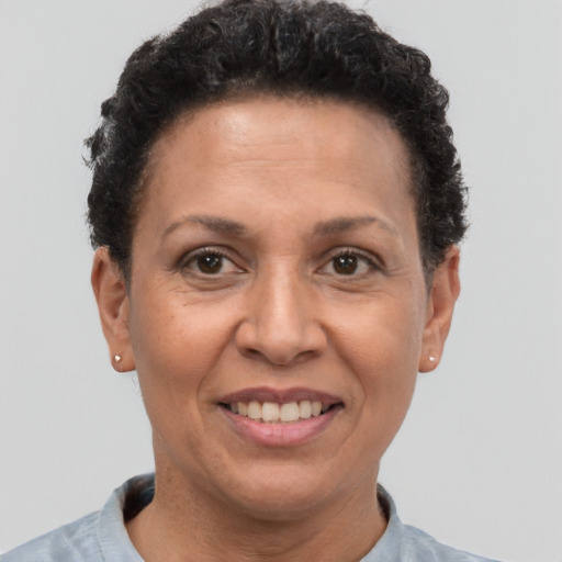 Joyful latino adult female with short  brown hair and brown eyes
