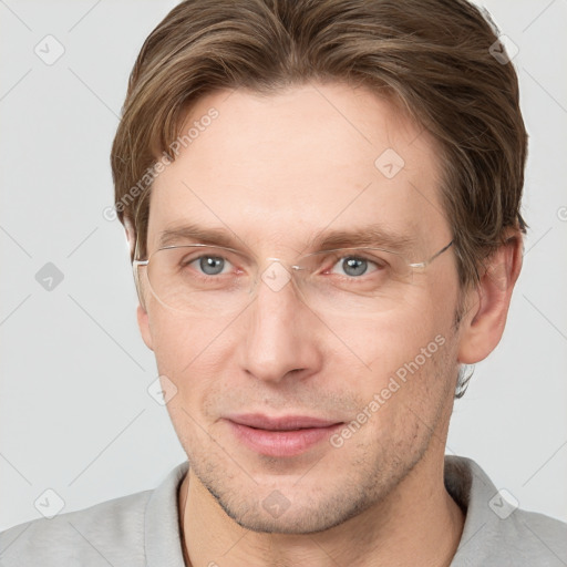 Joyful white adult male with short  brown hair and grey eyes