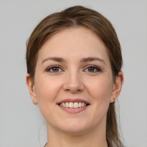 Joyful white young-adult female with long  brown hair and grey eyes