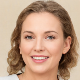 Joyful white young-adult female with medium  brown hair and green eyes