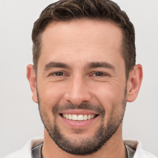 Joyful white young-adult male with short  brown hair and brown eyes