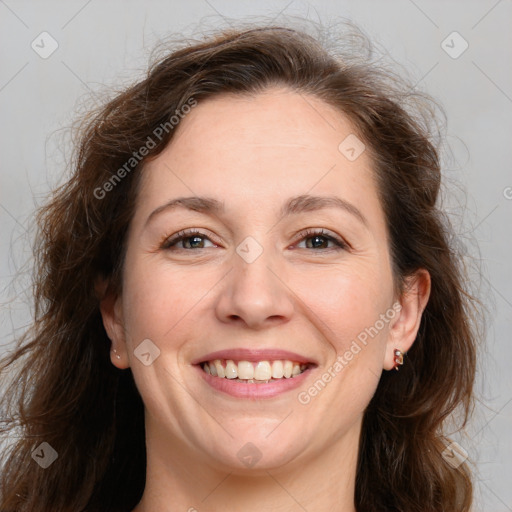 Joyful white adult female with long  brown hair and brown eyes