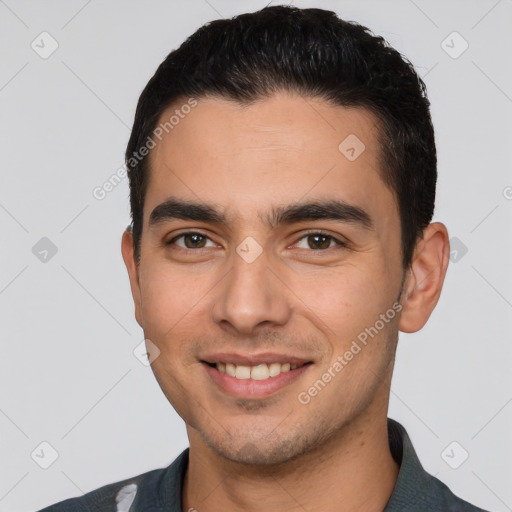 Joyful white young-adult male with short  black hair and brown eyes