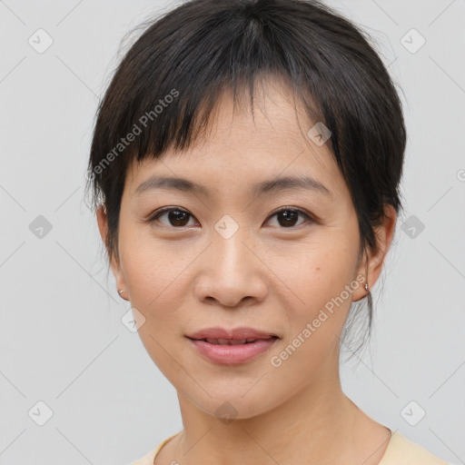 Joyful asian young-adult female with medium  brown hair and brown eyes