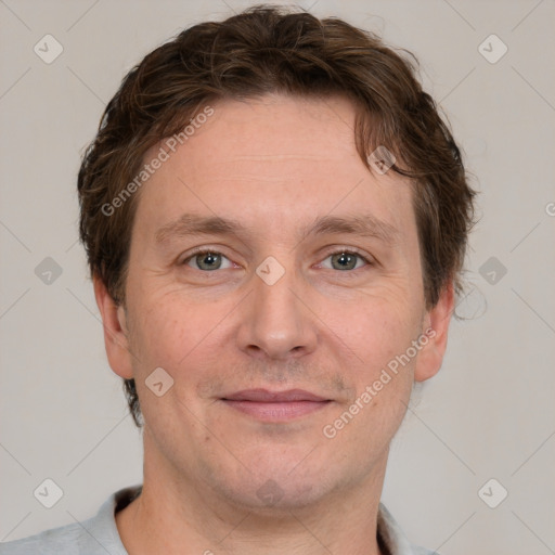 Joyful white adult male with short  brown hair and grey eyes