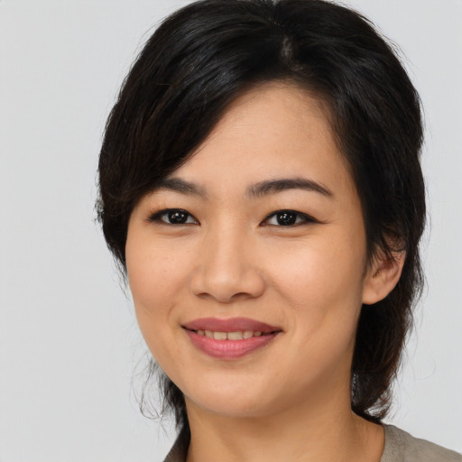 Joyful asian young-adult female with medium  black hair and brown eyes