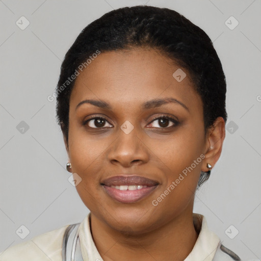 Joyful black young-adult female with short  black hair and brown eyes