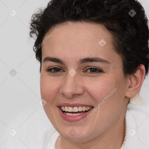 Joyful white young-adult female with short  brown hair and brown eyes