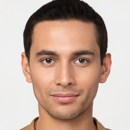 Joyful latino young-adult male with short  brown hair and brown eyes