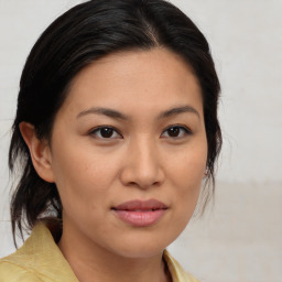 Joyful asian young-adult female with medium  brown hair and brown eyes