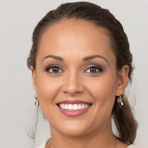 Joyful white young-adult female with long  brown hair and brown eyes