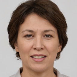 Joyful white adult female with short  brown hair and brown eyes