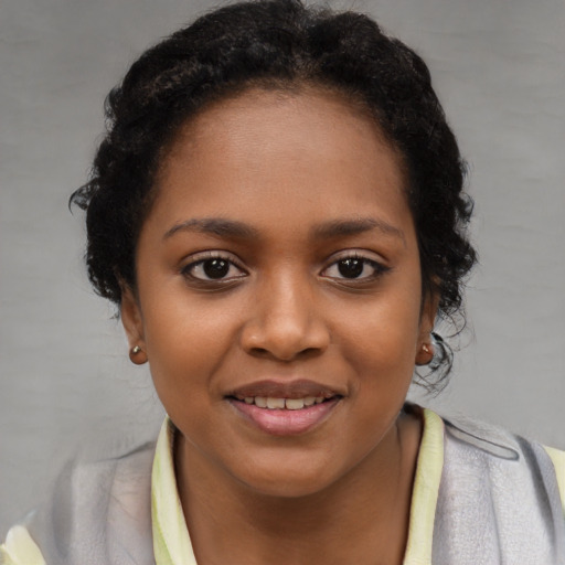 Joyful black young-adult female with short  brown hair and brown eyes