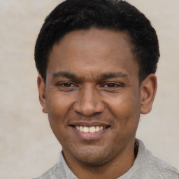 Joyful latino young-adult male with short  black hair and brown eyes