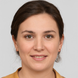 Joyful white young-adult female with medium  brown hair and brown eyes