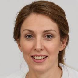 Joyful white young-adult female with medium  brown hair and grey eyes