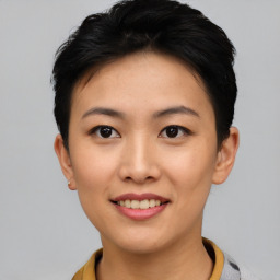 Joyful asian young-adult female with short  black hair and brown eyes