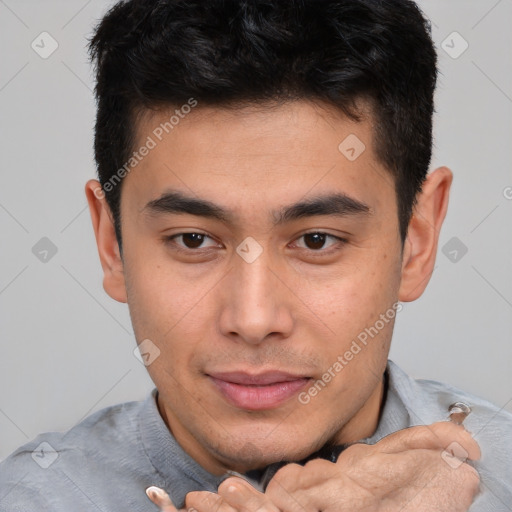 Joyful asian young-adult male with short  brown hair and brown eyes