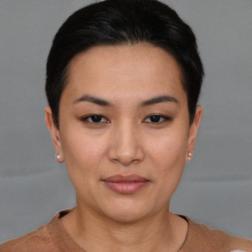 Joyful asian young-adult female with short  black hair and brown eyes
