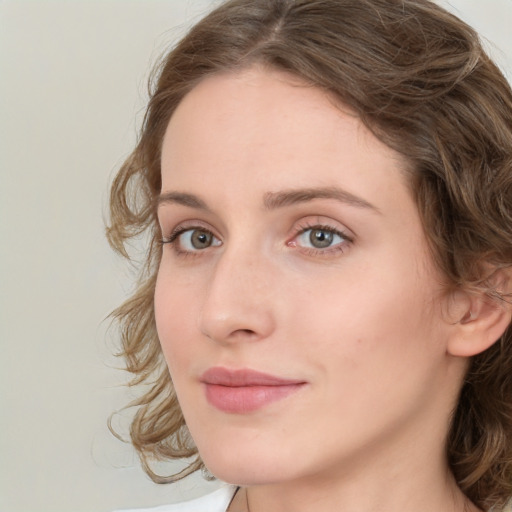 Joyful white young-adult female with medium  brown hair and green eyes