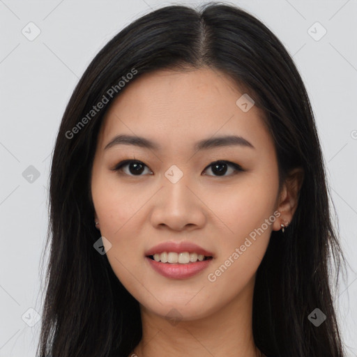 Joyful asian young-adult female with long  brown hair and brown eyes