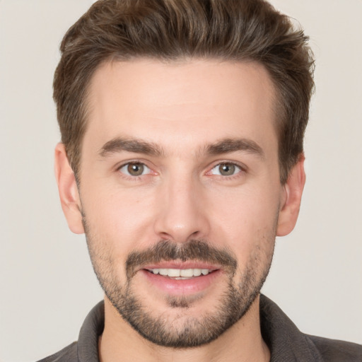 Joyful white young-adult male with short  brown hair and brown eyes