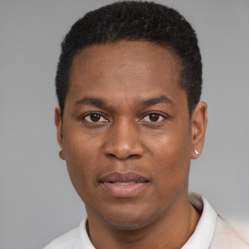 Joyful black young-adult male with short  black hair and brown eyes