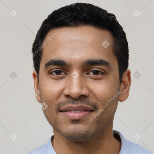 Joyful latino young-adult male with short  black hair and brown eyes