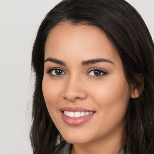 Joyful white young-adult female with long  black hair and brown eyes