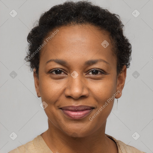 Joyful black adult female with short  brown hair and brown eyes