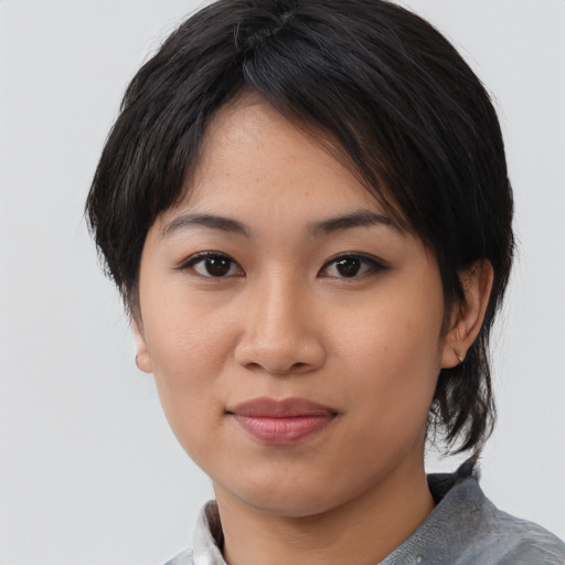 Joyful asian young-adult female with medium  black hair and brown eyes