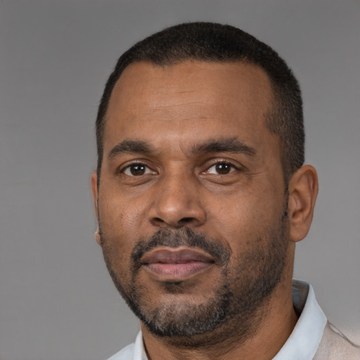 Neutral latino adult male with short  black hair and brown eyes