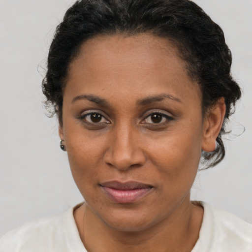 Joyful latino adult female with short  brown hair and brown eyes