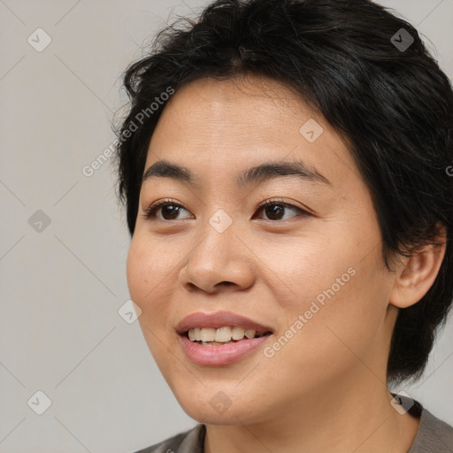 Joyful asian young-adult female with medium  black hair and brown eyes