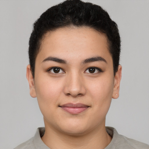 Joyful latino young-adult female with short  brown hair and brown eyes