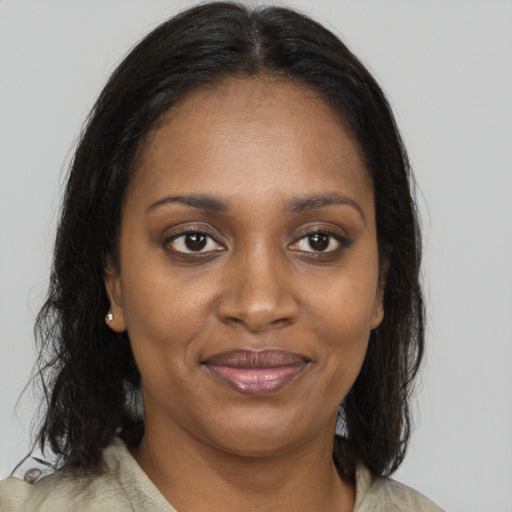 Joyful black young-adult female with medium  brown hair and brown eyes