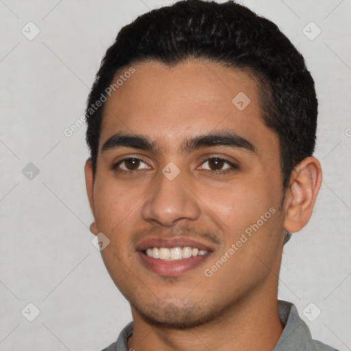 Joyful latino young-adult male with short  black hair and brown eyes