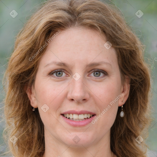 Joyful white adult female with long  brown hair and blue eyes