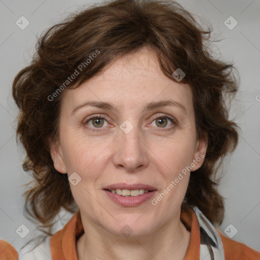 Joyful white adult female with medium  brown hair and blue eyes