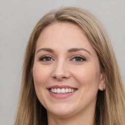 Joyful white young-adult female with long  brown hair and grey eyes