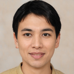 Joyful asian young-adult male with short  black hair and brown eyes