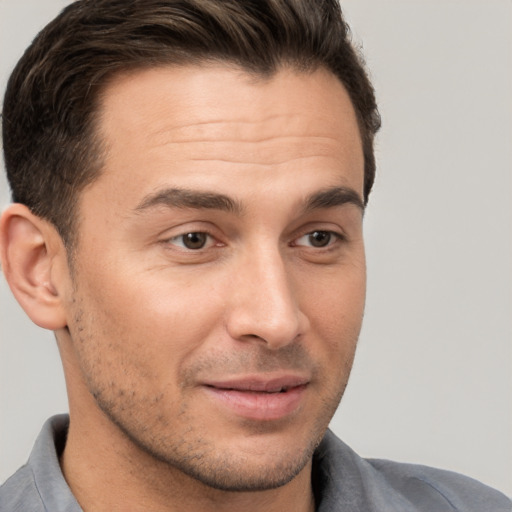 Joyful white young-adult male with short  brown hair and brown eyes