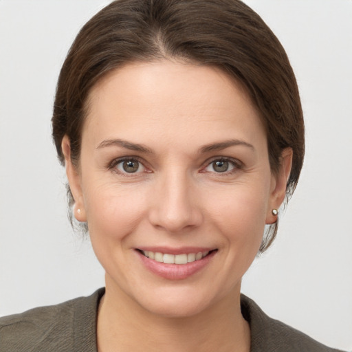 Joyful white young-adult female with short  brown hair and grey eyes